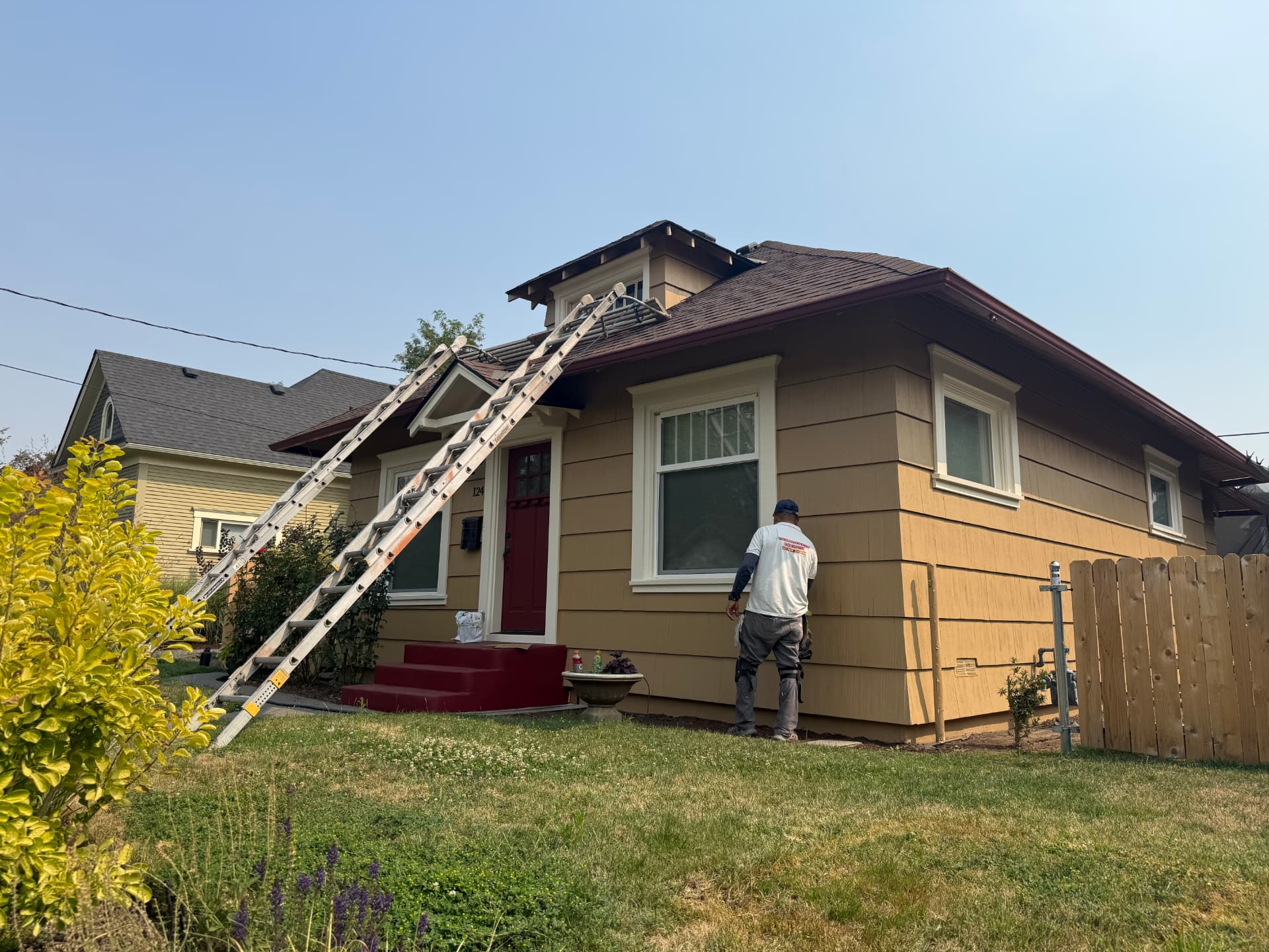 Molina Bro's painter working on a Walla Walla home exterior with ladders in place